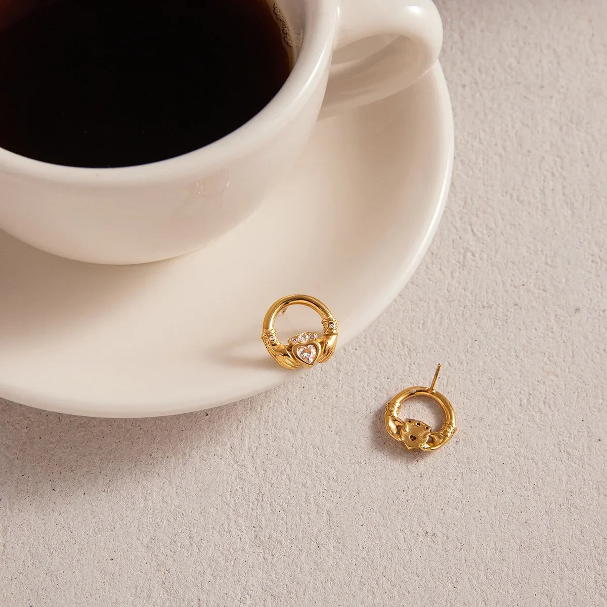 18K gold-plated friendship hand design titanium steel stud earrings with cubic zirconia. - Billien